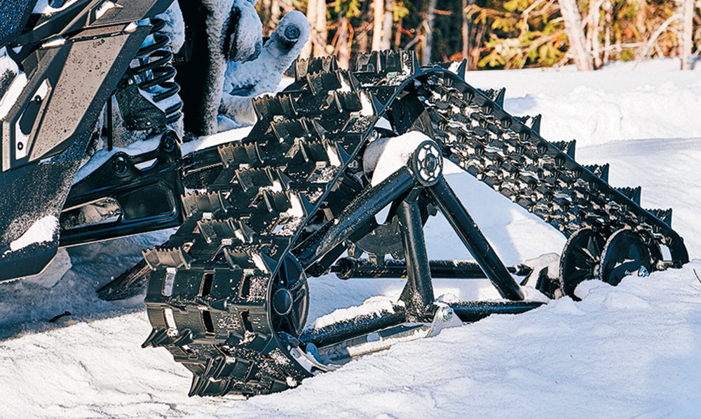 close view of treads flush on ground on ATV in snow
