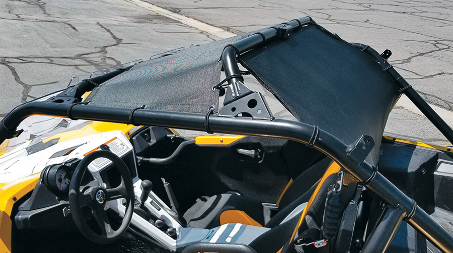 Photo of a Razorshade Mesh Roof, Windjammer Mesh Panel installed onto a yellow UTV's roof which is parked in a parking lot
